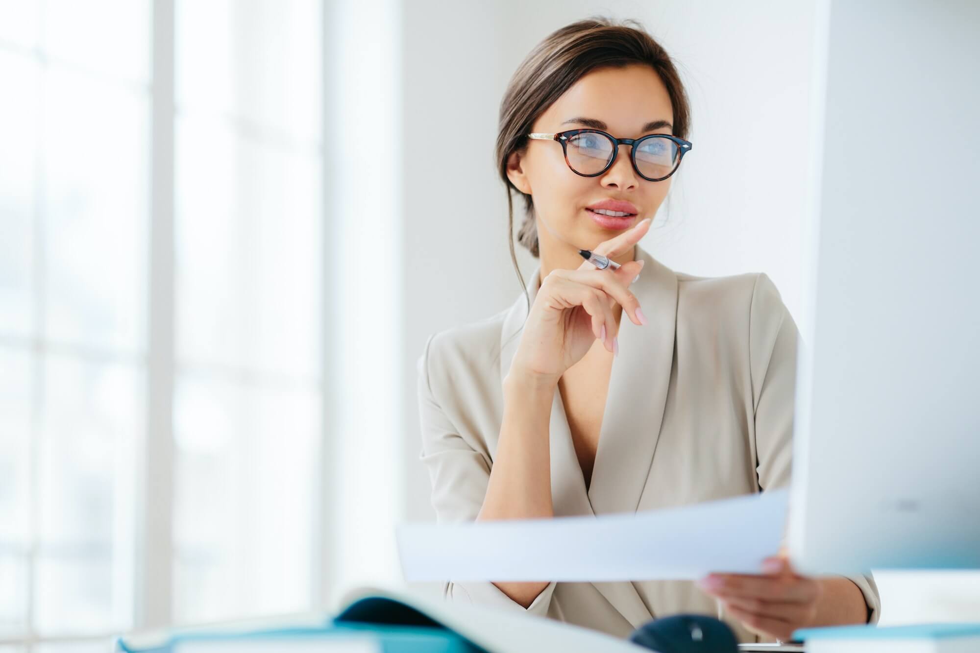 economist poses in coworking space, focused in monitor, verifies or checks figures