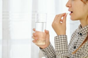 Woman taking birth control tablet